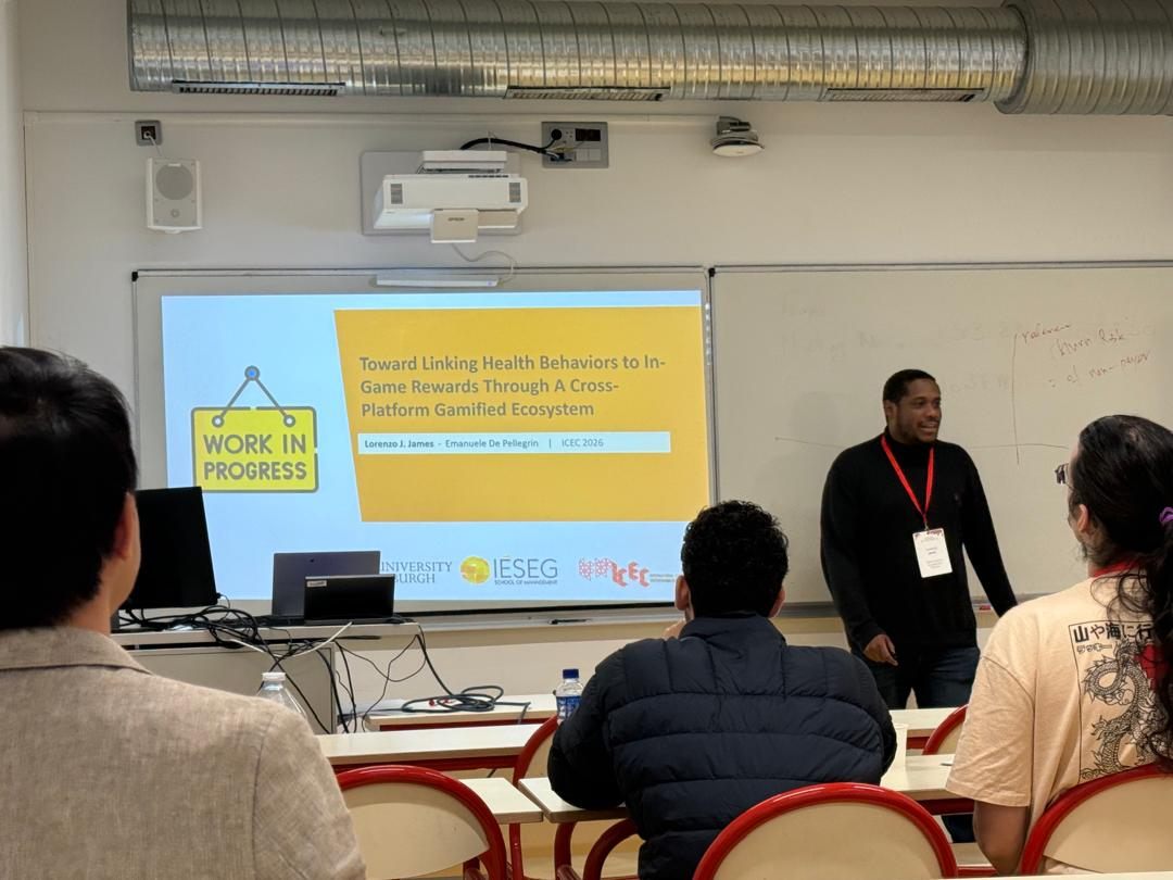 Lorenzo presenting the title slide of his paper to an audience in a classroom
